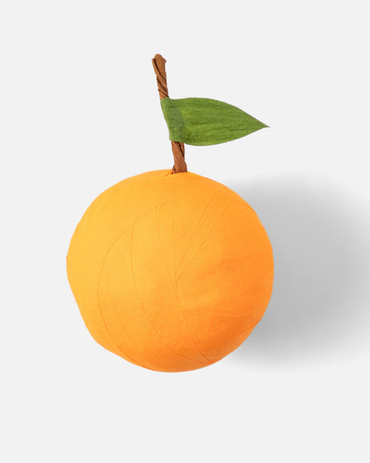 St. Nicholas Orange Surprise Ball, a crepe paper orange with a green leaf filled with small Catholic gifts for kids